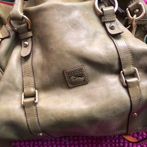 This is a satchel Dooney & Bourke Bag. The color is Olive Green.